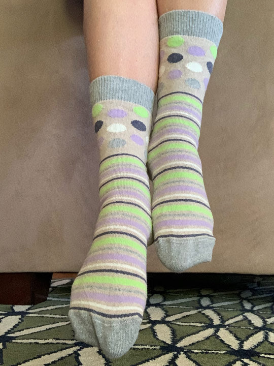 lifestyle of linen socks with gray, lime, lilac dots and stripes